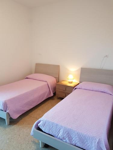 Postel nebo postele na pokoji v ubytování Casa Adua appartamento