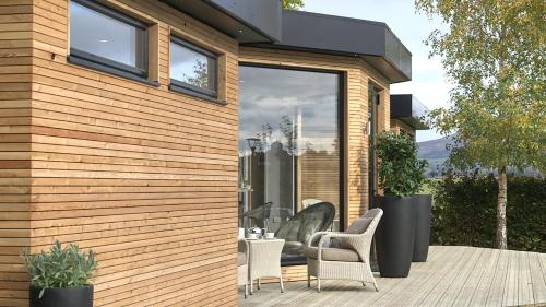 a house with a patio with chairs and a table at Fishmore Hall Hotel and Boutique Spa in Ludlow