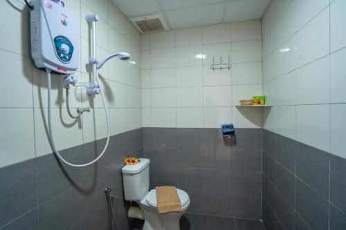 a bathroom with a shower and a toilet in it at Paretto Seaview Hotel in Pantai Cenang