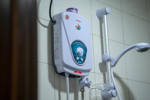 a soap dispenser is hanging on a wall at Paretto Seaview Hotel in Pantai Cenang