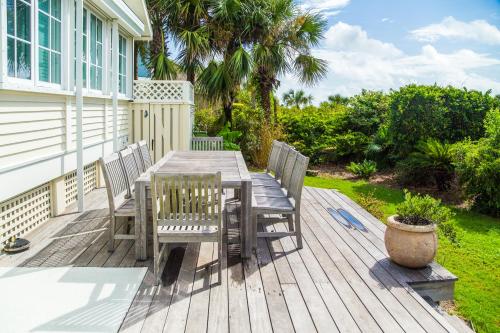 a wooden table and chairs on a deck at 9 Dune Lane in Hilton Head Island
