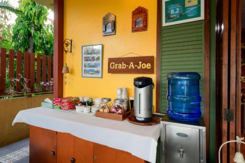 a table with a coffee maker on top of it at 88 Backpackers Hua Hin in Hua Hin