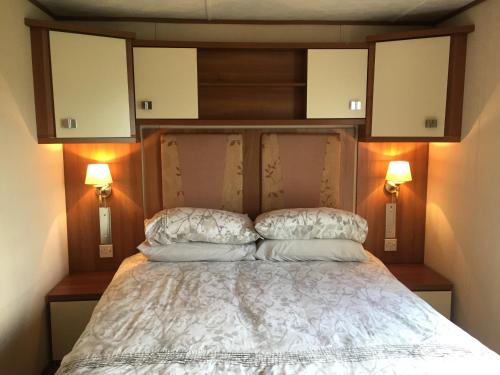 a bedroom with a bed with two pillows on it at 'Hartland Caravan' with Sea Views in Bideford