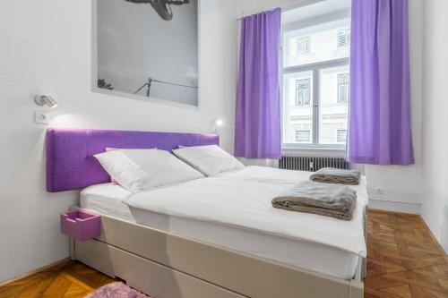 a bedroom with purple curtains and a large bed at Munda house Big design family friendly 4BR apt in Ljubljana