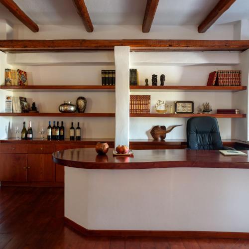 a bar in a room with a table and shelves at Aquaria Villa in Karterados