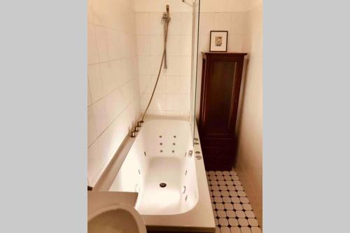 a bathroom with a bath tub and a toilet at Best location, beautiful and quiet Old Town apt. in Tallinn
