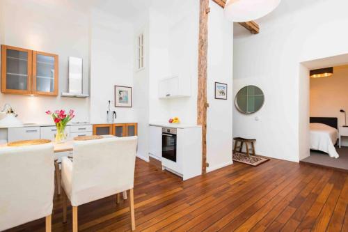 a kitchen and living room with a table and chairs at Best location, beautiful and quiet Old Town apt. in Tallinn
