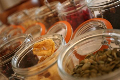 a bunch of glass jars filled with food on a table at Fishmore Hall Hotel and Boutique Spa in Ludlow