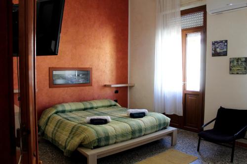sypialnia z łóżkiem i telewizorem na ścianie w obiekcie Sweet Home w Cagliari