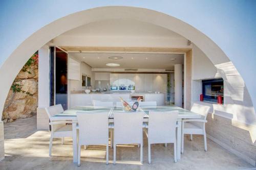 a kitchen and dining room with a table and chairs at Villa Ocean View in Portals Nous