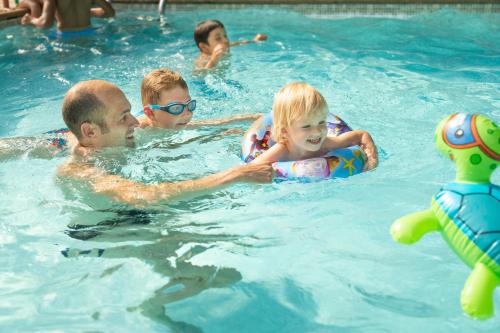 a group of people in a swimming pool at Green Park Hotel Brugge in Bruges