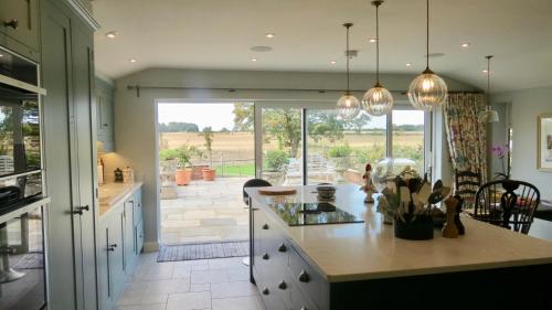 a kitchen with a view of a patio at Newmans Lodge in Lavenham