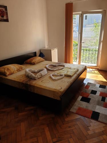 uma cama num quarto com uma grande janela em Milcov em Eforie Sud