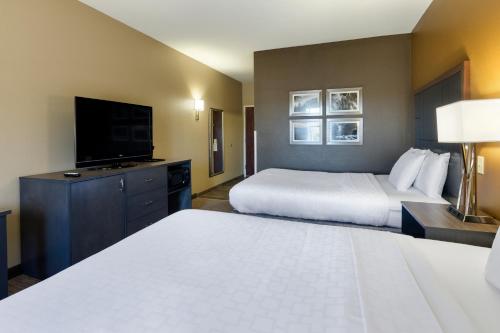 a hotel room with two beds and a flat screen tv at La Quinta by Wyndham Boone in Boone