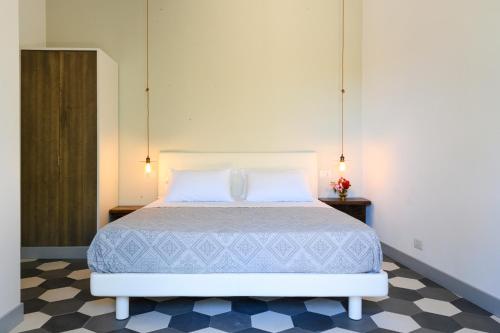 a bedroom with a large bed with two pillows at Dattilo in Torre Melissa