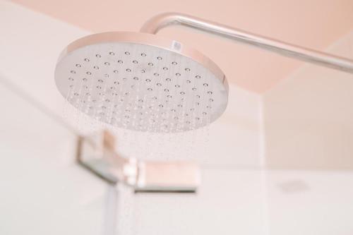 a shower head in a bathroom with a silver handle at Firefly in Bray