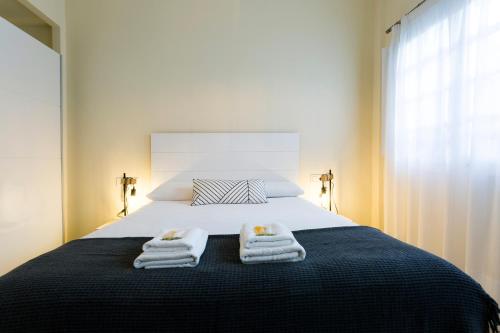 a bedroom with a bed with two towels on it at Olerki by Smiling Rentals in Hondarribia