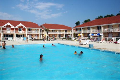 a group of people in the swimming pool at a hotel at Appartement SC4p in Le Verdon-sur-Mer