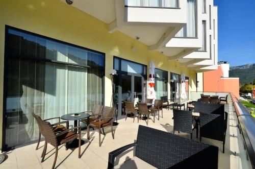 a patio with chairs and tables on a building at Hotel Fontana in Buzet