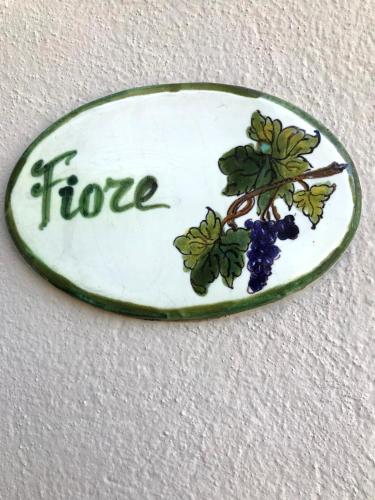 a stone sign with a branch of blueberries on it at Il Pezzatino in Rufina