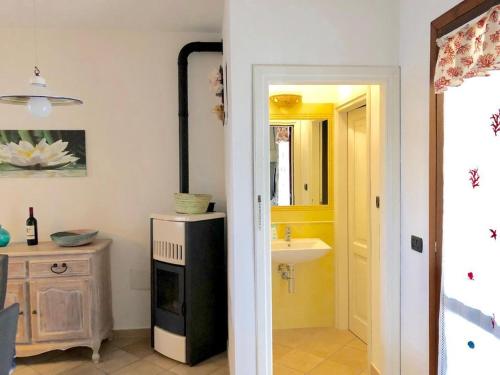 a kitchen with a sink and a refrigerator in a room at Villetta Il Corallo in San Teodoro