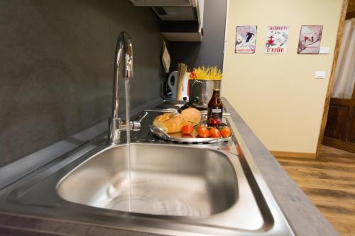 a sink in a kitchen with a plate of food at Love and magic in Limone in Limone Piemonte