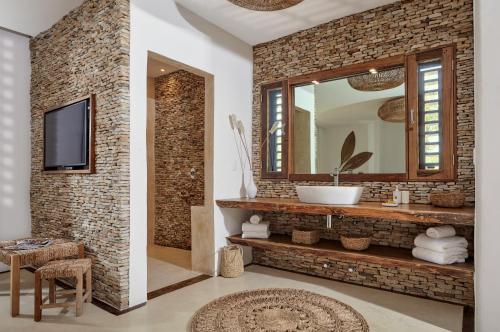 a bathroom with a sink and a mirror at Villa Praia - La Villa Group in Jericoacoara
