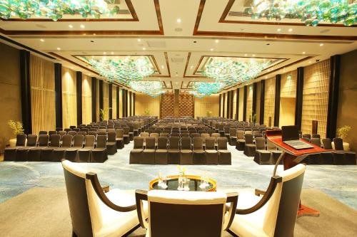 a large banquet hall with chairs and tables and a laptop at Crowne Plaza New Delhi Mayur Vihar Noida by IHG in New Delhi