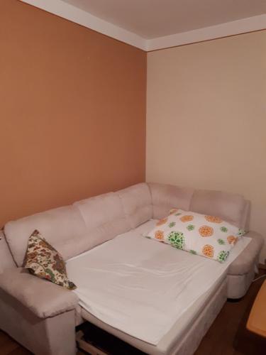 a white couch with two pillows in a room at Eventgasthaus Greil in Leitzersdorf