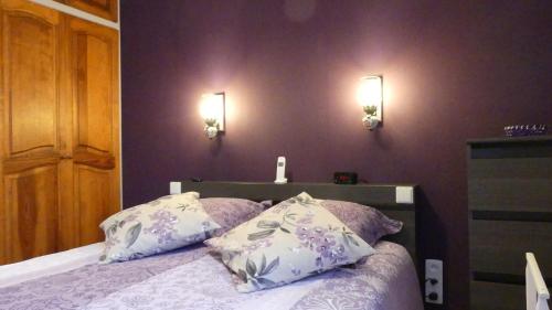 a bedroom with a bed with two pillows on it at Au Cygne in Hoerdt