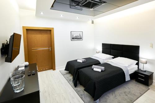 Ένα ή περισσότερα κρεβάτια σε δωμάτιο στο Prestige Apartamenty VINCI Centrum
