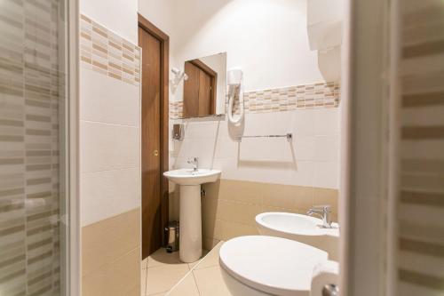 a small bathroom with a sink and a toilet at San Gennaro B&B in Naples