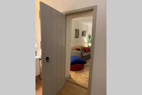 an open door to a living room with a couch at Stunning Barn private hot tub Malvern & Worcester Sleeps 6 in Worcester