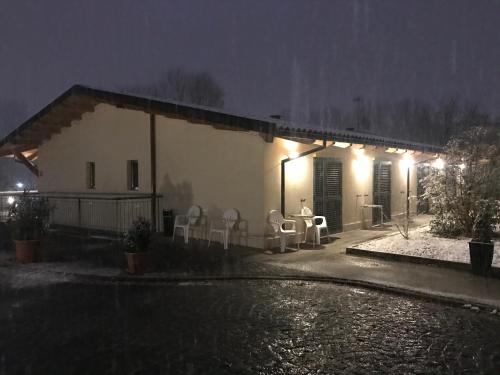 a house with chairs and a patio at night at B&B Oasi Vetoio in LʼAquila