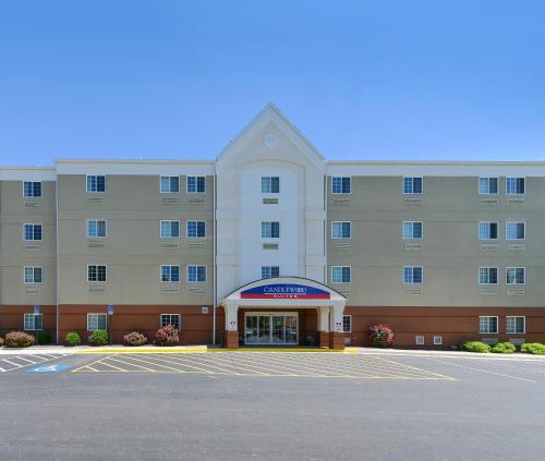 an empty parking lot in front of a hotel at Candlewood Suites Winchester by IHG in Winchester