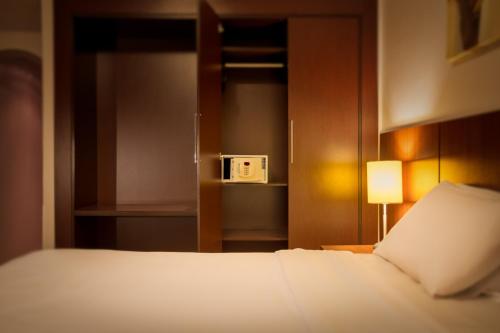 Postel nebo postele na pokoji v ubytování H3 Hotel Paulista