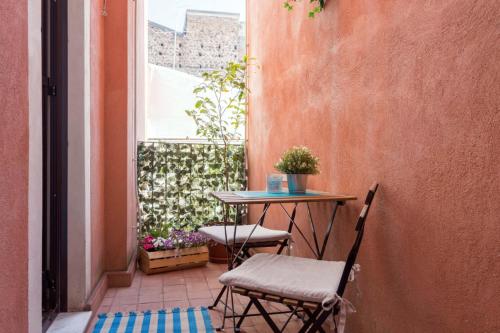 een kleine tafel en stoelen op een patio bij Centre Apartment Grotte Bianche 2 in Catania