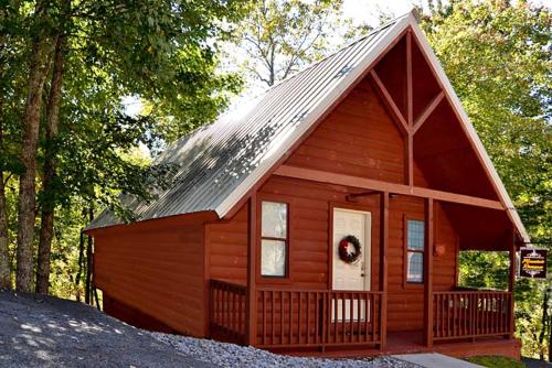 a small red cabin with a gambrel roof at Mountain Romance in Gatlinburg