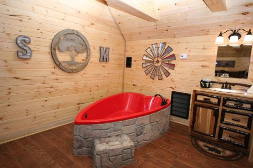 a bathroom with a red tub in a cabin at Sweet Memories in Gatlinburg