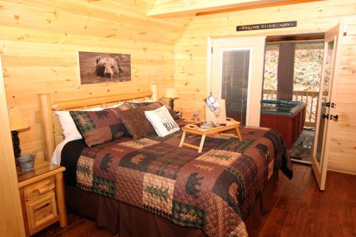 a bedroom with a bed in a log cabin at Sweet Memories in Gatlinburg