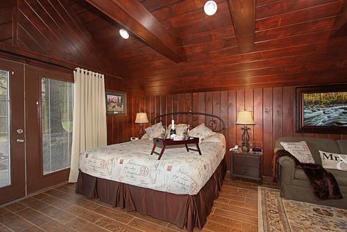 a bedroom with a bed and a table in it at Burnin' Love in Gatlinburg