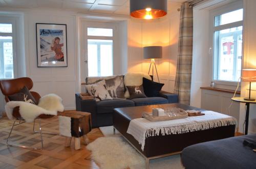 a living room with a couch and a coffee table at Alpine Haus in Göschenen