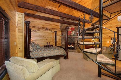 a bedroom with a bed and a fire place at Lover's Loft in Gatlinburg