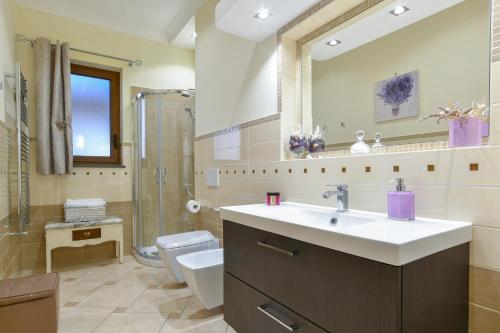 a bathroom with a sink and a toilet and a mirror at Casa Vacanza Villa Girasole in Massa Lubrense