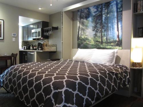a bedroom with a large bed with a large window at Gondola Lodge in South Lake Tahoe