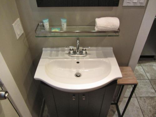 a bathroom with a white sink and a shelf at Gondola Lodge & Tahoe Beach Club in South Lake Tahoe