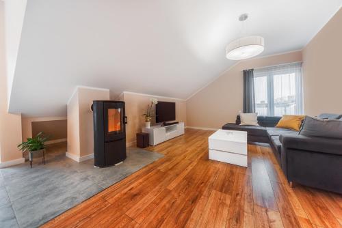 a living room with a couch and a tv at Marittimo Resort in Świnoujście