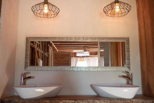 a bathroom with two sinks and a mirror at LaIsla Holbox Villa in Holbox Island