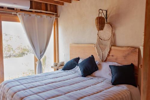 a bedroom with a large bed with a swing at LaIsla Holbox Villa in Holbox Island