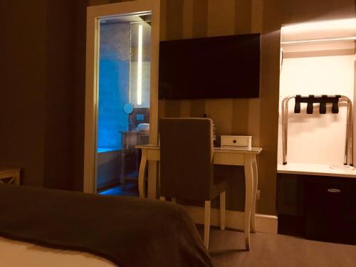 a bedroom with a bed and a table and a mirror at 29 Venti Luxury in Palermo